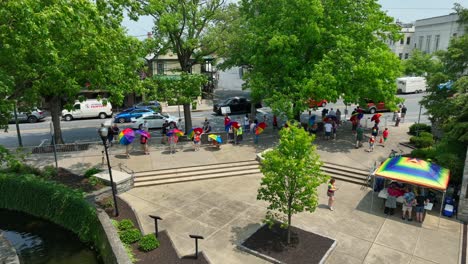 Drone-view-of-a-gathering-of-people-at-a-park-for-a-pride-festival-on-a-beautiful-summer-day