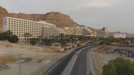 Dead-Sea-hotels-and-waterfront-highway-on-a-beautiful-morning,-Aerial-view