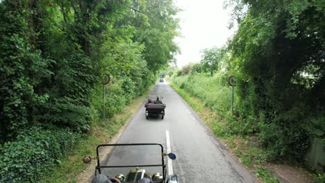 Vintage-cars-drive-down-a-leafy-Irish-lane-in-Kildare-on-a-vintage-rally-classic-motoring-on-a-warm-summer-morning