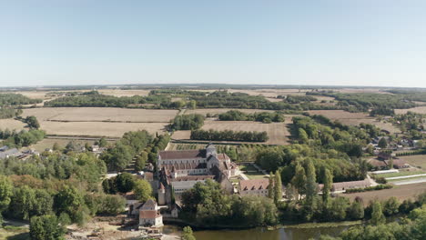 Aerial-drone-point-of-view-of-the-beautiful-Abbaye-de-Fontgombault-or-Abbey-of-Notre-Dame
