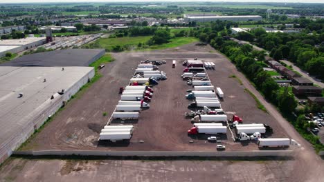 overview-of-yard-parking-lot-with-semi-trucks-and-trailers---reefers,-dry-van,-flatbeds,-stingers,-bob-tails