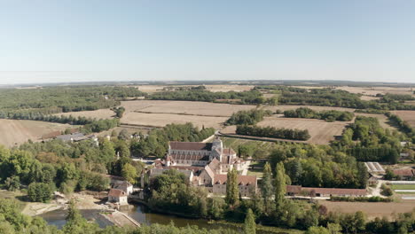 Aerial-drone-point-of-view-of-the-beautiful-Abbaye-de-Fontgombault-or-Abbey-of-Notre-Dame
