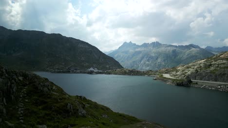 Aerial-approach-of-Hotel-Grimsel-Passhöhe-or-Grimselpass-in-Switzerland-from-Totensee-or-Titinsee-Lake-in-summertime