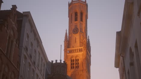 Dawn-tilt-shot-of-Historic-Center-Belfry-in-Bruges,-Belgium
