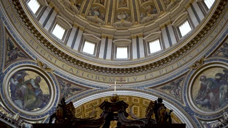 An-establishing-shot-tilting-up-to-reveal-the-beautiful-artwork-and-mosaics-which-surround-the-Michelangelo-dome-in-the-Saint-Peter's-Basilica,-Vatican-City,-Italy