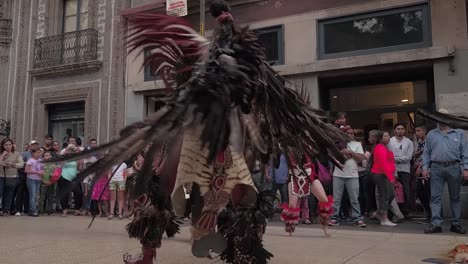 Slow-motion-shot-of-dancers-in-costumes-dancing-in-the-street-in-front-of-a-crowd
