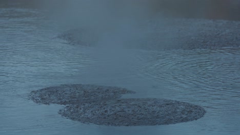 Boiling-hot-geothermal-volcanic-mud-pool,-closeup-shot-steamy-lake-bubbling-mud-and-steam