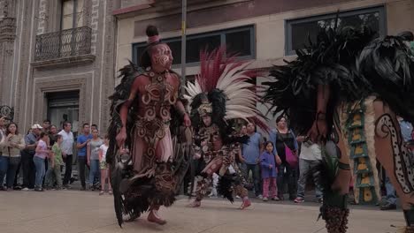 Slow-motion-close-up-shot-of-tribal-dancers-performing-in-the-middle-of-the-street