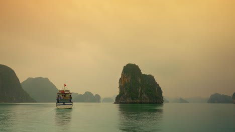 Tranquil-Evening-in-Ha-Long-Bay:-Tourist-Ship-Amidst-Limestone-Peaks