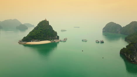Aerial-View-of-Ha-Long-Bay:-Ti-Top-Island-and-Limestone-Peaks-surrounded-by-ships