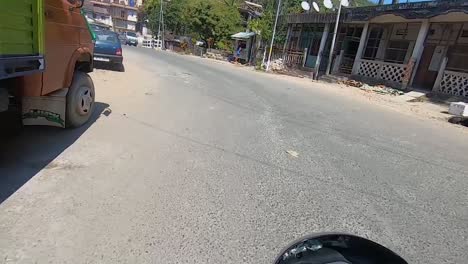 motorcycle-rider-view-of-curvy-road-landscape-crossing-city-at-day-video-is-taken-at-dawki-meghalaya-north-east-india-on-July-06-2023