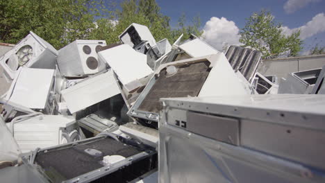 Broken-and-discarded-bulky-household-appliances-dumped-at-landfill