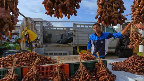 Vendors-selling-hanging-dried-delicious-dates-at-Midoun-market-of-Djerba-in-Tunisia