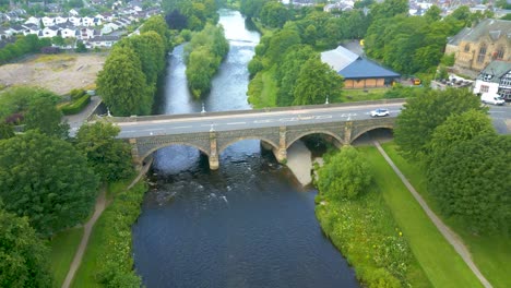 Aerial-Drone-shot-flying-northwest-over-the-River-Tweed-towards-the-Tweed-Bridge-in-the-town-of-Peebles-in-the-Scottish-Borders