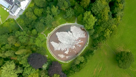Aerial-Drone-rotating-vertical-ascent-over-the-Great-Polish-Map-of-Scotland-at-the-village-of-Eddleston,-Scottish-Borders