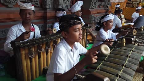 Balinese-Children-Play-Gamelan-Traditional-Religious-Music-at-Temple-Ceremony-Bali-Indonesia,-Cultural-Ancient-Art