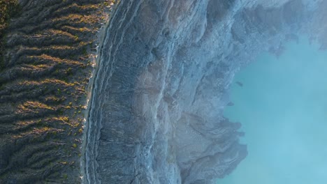 Drone-top-down-flying-through-Ijen-Crater-in-Indonesia-during-sunrise