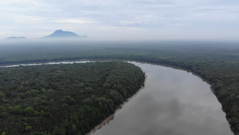 Drone-Sarawak-river-with-mountain-Serapi-behind-during-evening