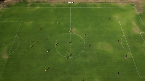 Aerial-establishing-shot-showing-start-of-soccer-match-during-beautiful-sunny-weather-in-Australia---Drone-tilt-down