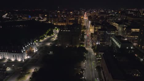 Cinematic-aerial-footage-of-downtown-Ottawa-at-night-tilting-up-with-Wellington-Street-in-focus-revealing-the-unique-cityscape,-Drone,-Canada,-Capital,-Drone