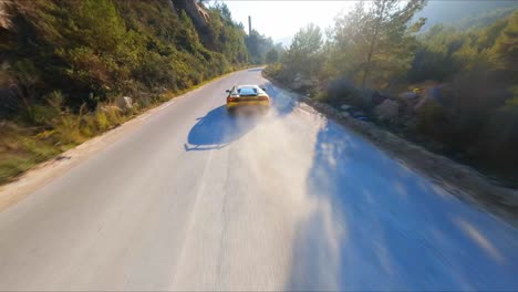 Epic-FPV-aerial-drone-following-a-yellow-Lamborghini-along-a-scenic-highway