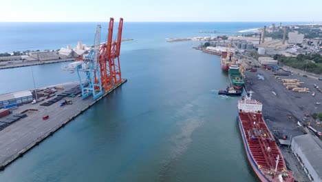 Aerial-forward-view-of-cranes-and-containers-at-Haina-port-in-Santo-Domingo,-Dominican-Republic
