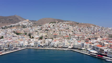 Aerial:-Slow-Pan-shot-of-picturesque-Emoupoli-town-of-Syros-island-,Cyclades,-Greece
