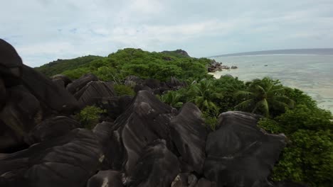 Fpv-drone-flying-on-a-Anse-Source-d'Argent-beach-in-Seychelles-on-an-Island-Mahe,-video-of-incredible-trees,-Seychelles-rocks,-seaside,-and-surrounding-Seychelles-landscapes
