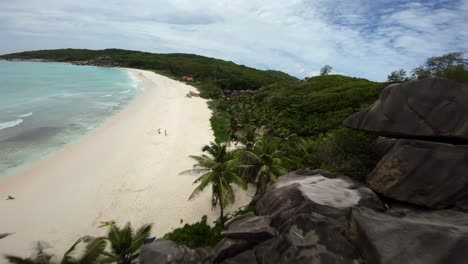 Fpv-drone-flying-on-a-beach-in-Seychelles-on-an-Island-Mahe,-video-of-incredible-trees,-Seychelles-rocks,-seaside,-and-surrounding-Seychelles-landscapes