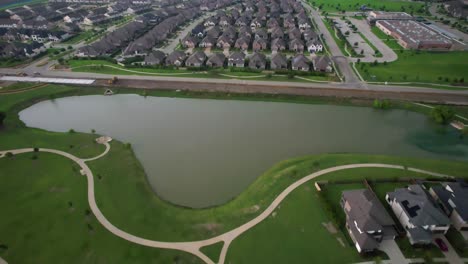 Aerial-footage-of-a-pond-located-in-Windsong-Ranch-in-Propser-Texas