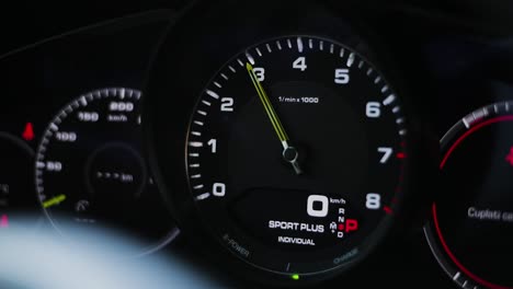 Close-up-shot-of-the-RPM-gauge,-revving-a-luxury-sport-car