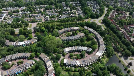Orbiting-aerial-view-of-the-Rozendaal-neighborhood-located-in-the-town-of-Leusden,-and-was-built-in-the-1970s-with-is-easily-recognizable-curved-design