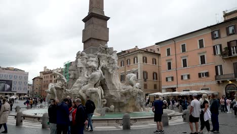 Tourists-Visiting-The-Fountain-Of-The-Four-Rivers-In-Piazza-Navona-In-Rome