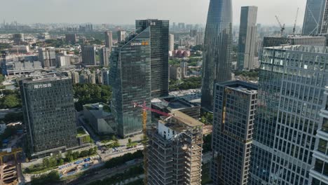 Aerial-view-of-construction-and-high-rise-business-headquarters,-in-sunny-Guangzhou,-China