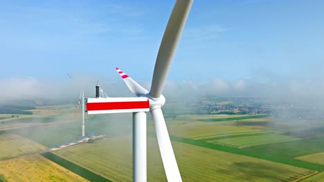 Motionless-Wind-Turbines-In-Fog-Clouds-On-A-Sunny-Morning