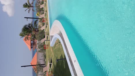 Vertical-shot-of-empty-Swimming-pool-of-Hilton-Garden-Inn-Hotel-and-Marina-with-restaurant-in-La-Romana---Dominica-Republic-Island-in-summer