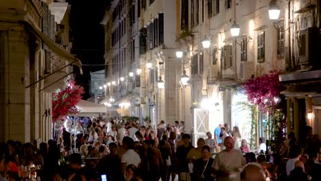 Fast-Forward-Timelapse-Shot-of-People-Walking-in-Old-Town-Alley-Shops-in-Corfu-Kerkyra-Greece-at-Night