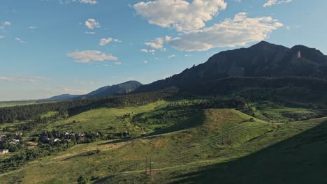 Luftaufnahme-über-Den-Bewaldeten-Hügeln-Von-Boulder-Mit-Den-Flatirons-Berggipfeln-Im-Hintergrund,-Colorado,-USA