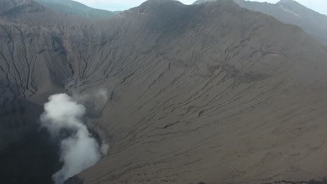 Drone-hiking-to-mountain-Bromo-revealing-active-smoking-volcano