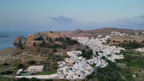 Aerial-footage-of-the-Acropolis-of-Lindos-above-Lindos-town-at-sunrise