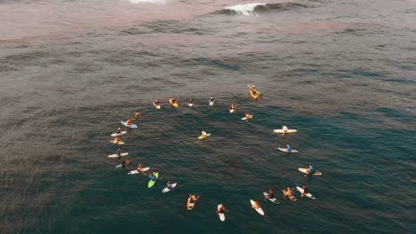 AERIAL-SLOWMO:-Group-of-surfers-forming-a-circle-on-the-sea-in-a-funeral's-ceremony-in-Canary-Islands