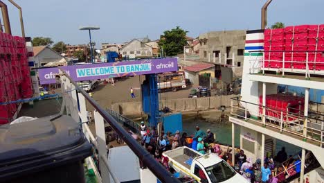 African-Locals-Boarding-Ferry-At-Banjul-Ferry-Terminal-In-Banjul,-The-Gambia-high-angle