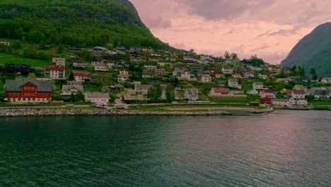 Tranquil-Norwegian-fjord-town-as-viewed-from-a-boat-entering-the-harbor
