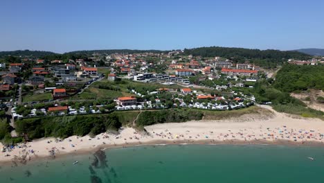 Aerial-Footage-of-Splendid-Beach-Resort-and-Village-Surrounded-by-Small-Forest