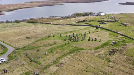 Tilting-drone-shot-of-the-Callanish-Standing-Stones-on-the-Isle-of-Lewis,-part-of-the-Outer-Hebrides-of-Scotland