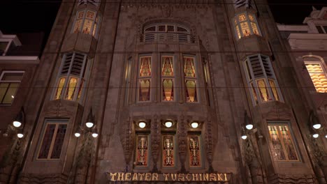 Beautiful-exterior-view-of-the-entrance-at-night,-of-the-Tuschinski-Cinema