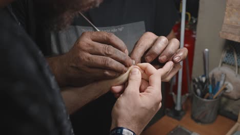 Helpful-hand-removing-splinter-from-another-person's-hand---workshop