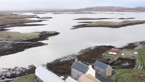 Tilting-drone-shot-of-the-Taigh-Chearsabhagh-Museum-and-Arts-Centre-in-Lochmaddy-on-the-island-of-North-Uist,-part-of-the-Outer-Hebrides-of-Scotland