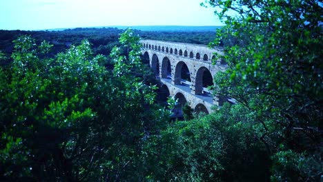 historic-stone-arch-bridge-made-of-sandstone-over-a-gorge-in-france-by-the-romans-in-the-middle-of-nature