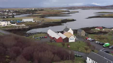 Descending-drone-shot-of-the-Taigh-Chearsabhagh-Museum-and-Arts-Centre,-and-the-moor-and-peatland-surrounding-Lochmaddy-on-the-island-of-North-Uist,-part-of-the-Outer-Hebrides-of-Scotland